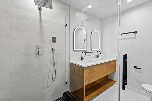 bathroom with a shower with door, vanity, and toilet