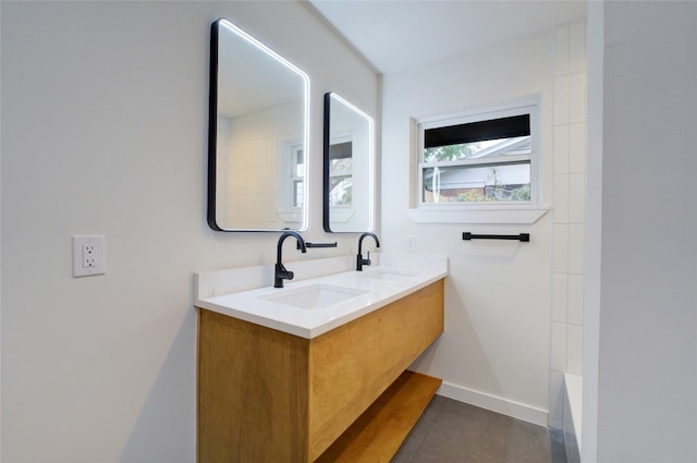 bathroom featuring vanity and a tub