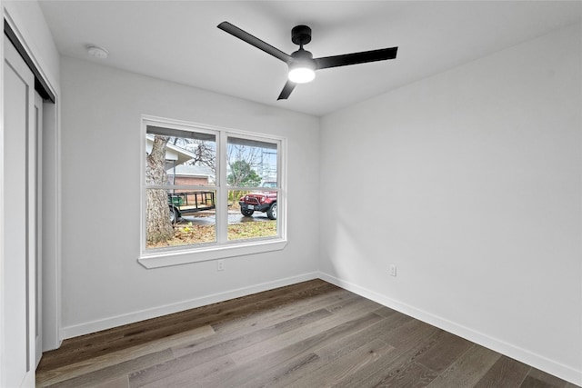 unfurnished bedroom featuring ceiling fan, a closet, and wood-type flooring