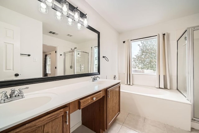 bathroom featuring tile patterned floors, separate shower and tub, and vanity