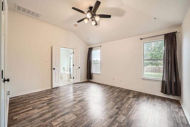 spare room featuring ceiling fan, dark wood-type flooring, and vaulted ceiling