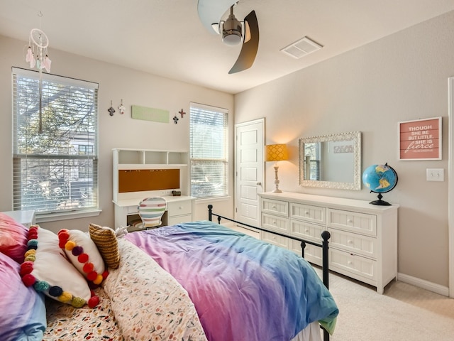 bedroom featuring ceiling fan and light carpet