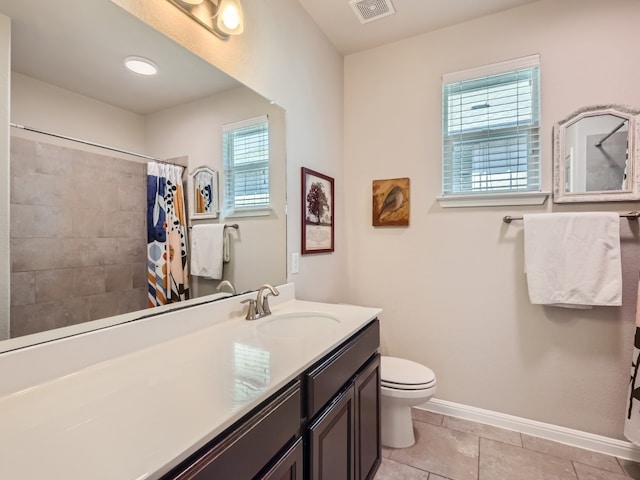 bathroom featuring walk in shower, plenty of natural light, vanity, and tile patterned flooring