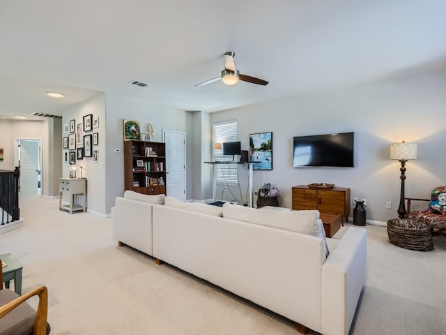 living room featuring light colored carpet and ceiling fan