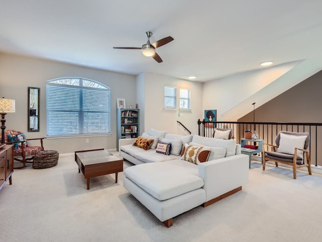 carpeted living room with ceiling fan