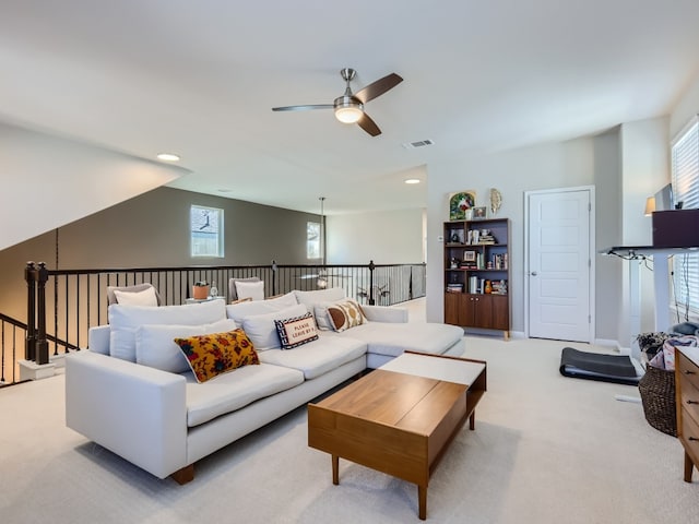 carpeted living room featuring ceiling fan and a healthy amount of sunlight