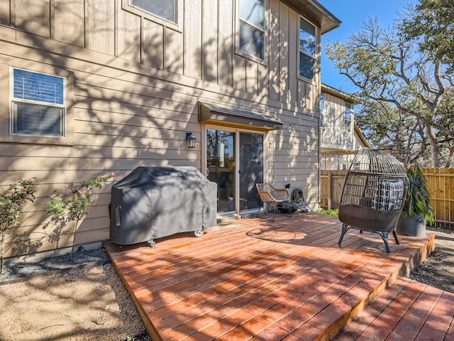 wooden terrace featuring a grill