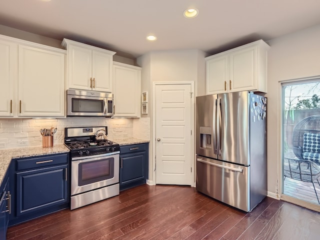 kitchen featuring dark hardwood / wood-style flooring, blue cabinets, and appliances with stainless steel finishes