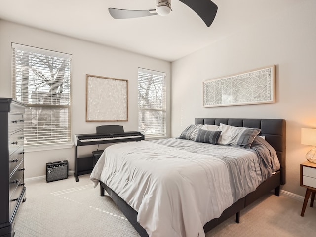 bedroom with ceiling fan and light colored carpet