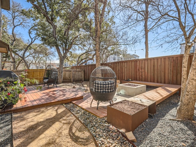 view of patio / terrace with a deck and a fire pit