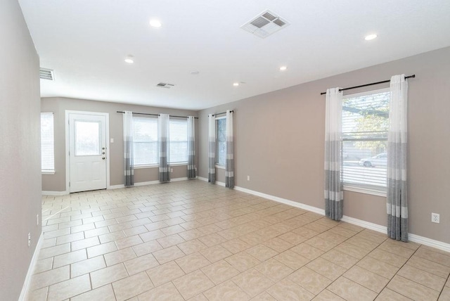 tiled spare room featuring a wealth of natural light