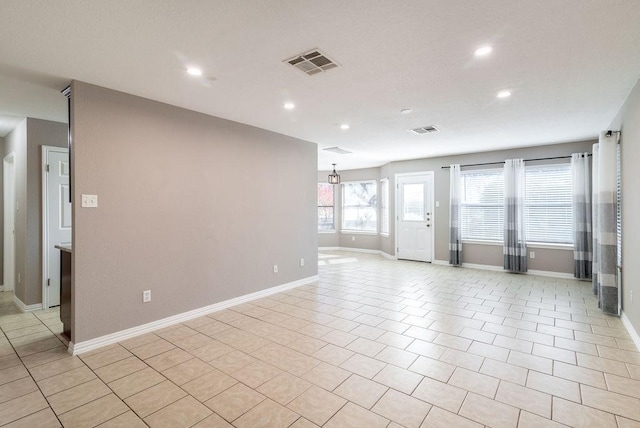 spare room featuring light tile patterned floors