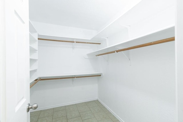 spacious closet featuring light tile patterned floors