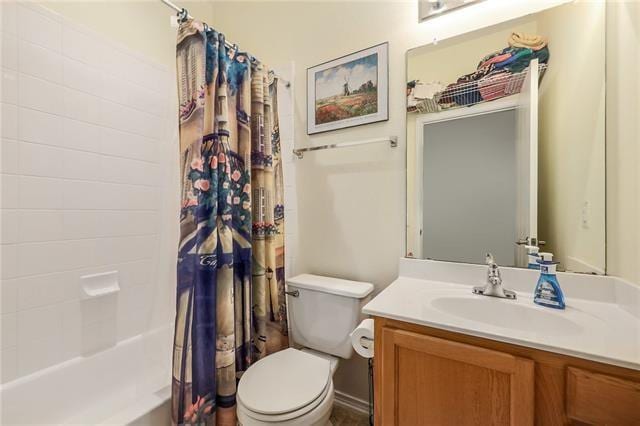 full bathroom with vanity, toilet, and shower / bath combo with shower curtain