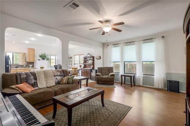 living room featuring ceiling fan and light hardwood / wood-style flooring