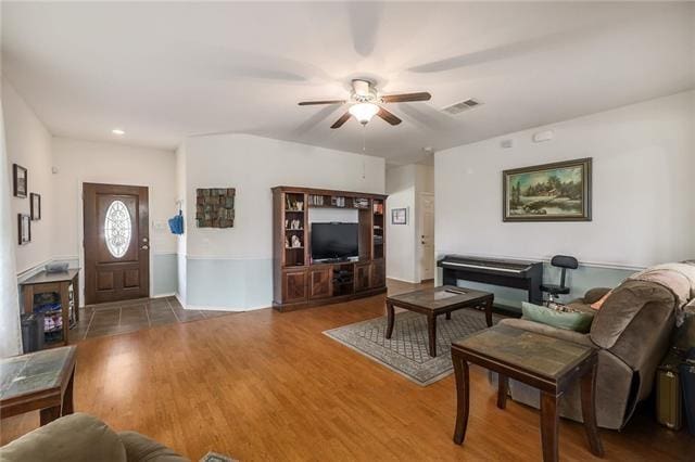 living room featuring hardwood / wood-style flooring and ceiling fan