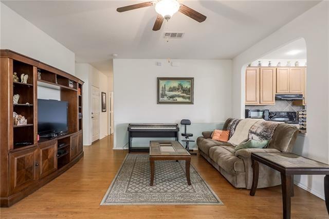 living room with ceiling fan and light wood-type flooring