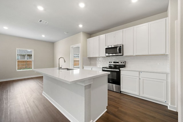 236 Lazy Lizzy Rd, Jarrell, TX 76537 - kitchen with appliances with stainless steel finishes, a sink, dark wood-style floors, backsplash, and a center island with sink