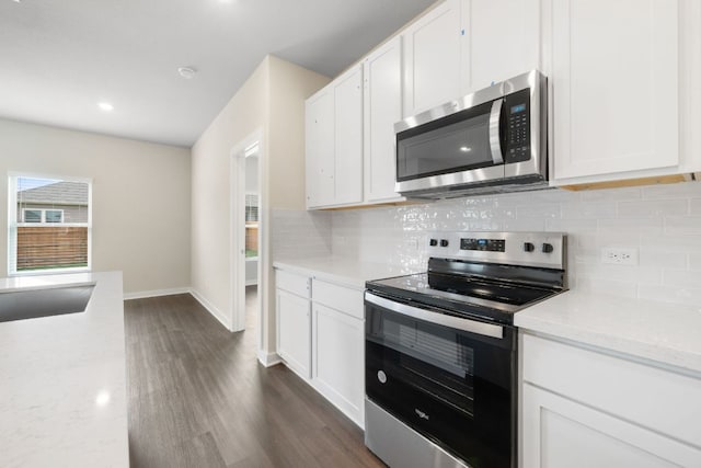 236 Lazy Lizzy Rd, Jarrell, TX 76537 - kitchen featuring appliances with stainless steel finishes, decorative backsplash, dark wood-style floors, white cabinets, and recessed lighting