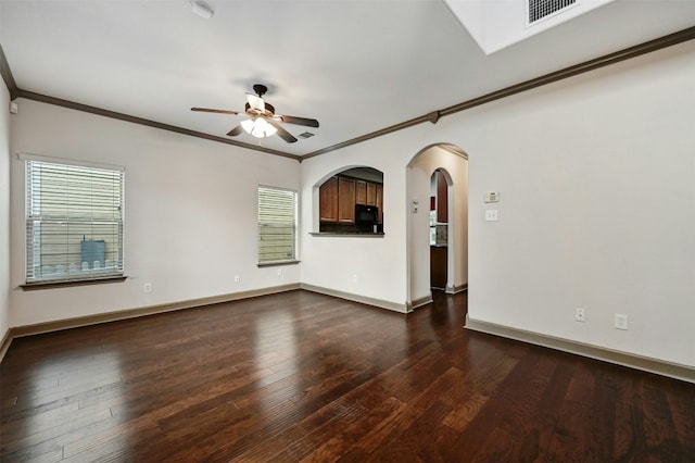 unfurnished room featuring a wealth of natural light, dark wood-type flooring, and ceiling fan