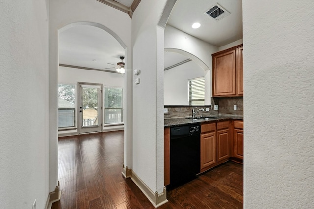 kitchen featuring dishwasher, dark wood-type flooring, sink, ceiling fan, and decorative backsplash