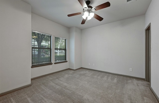 unfurnished room with ceiling fan and light colored carpet