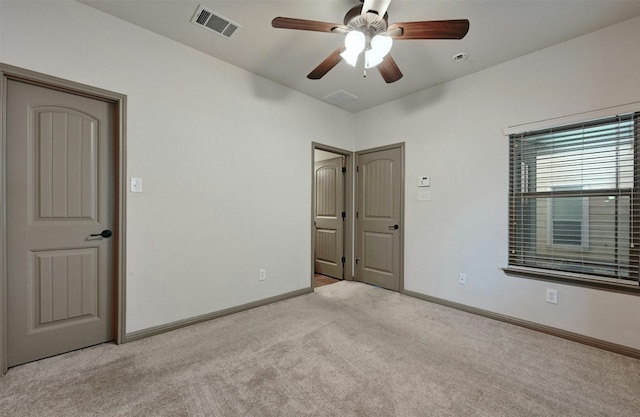 unfurnished bedroom featuring ceiling fan and light carpet