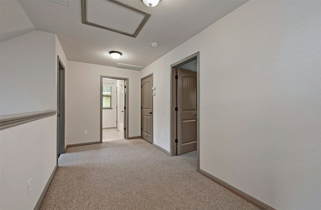 corridor with light carpet and lofted ceiling