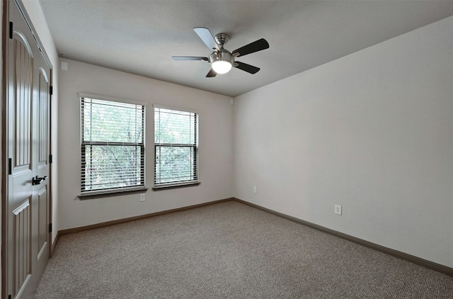 carpeted empty room with ceiling fan