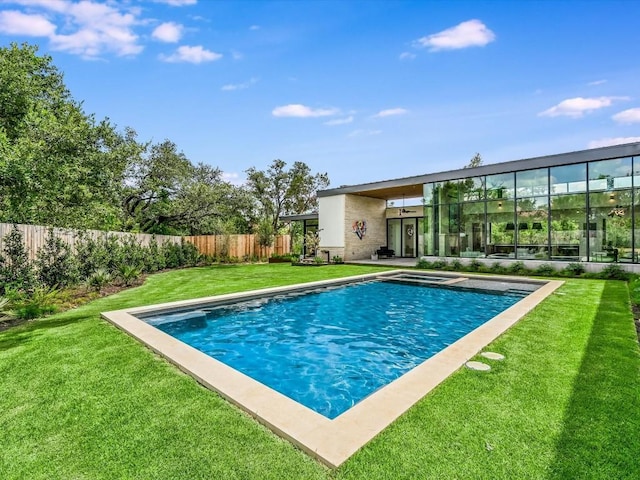 view of pool with a yard