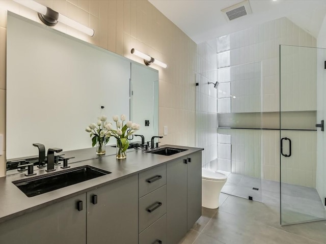 bathroom featuring walk in shower, vanity, tile walls, tile patterned flooring, and toilet