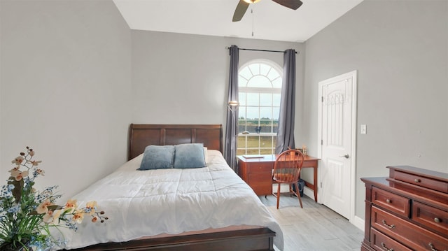 bedroom featuring ceiling fan, light hardwood / wood-style floors, and multiple windows