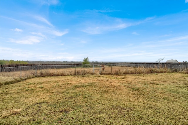 view of yard with a rural view and fence