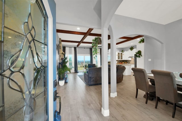 foyer entrance with beam ceiling, light hardwood / wood-style floors, and coffered ceiling