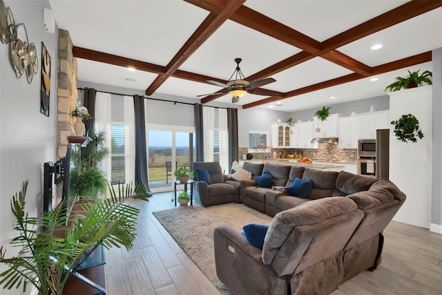 living room featuring ceiling fan, light hardwood / wood-style flooring, beamed ceiling, and coffered ceiling