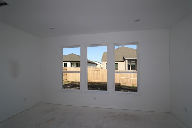 unfurnished room featuring a wealth of natural light and concrete floors