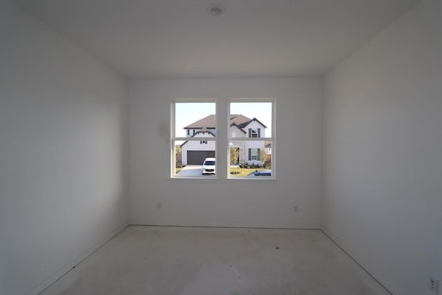 unfurnished room with concrete flooring