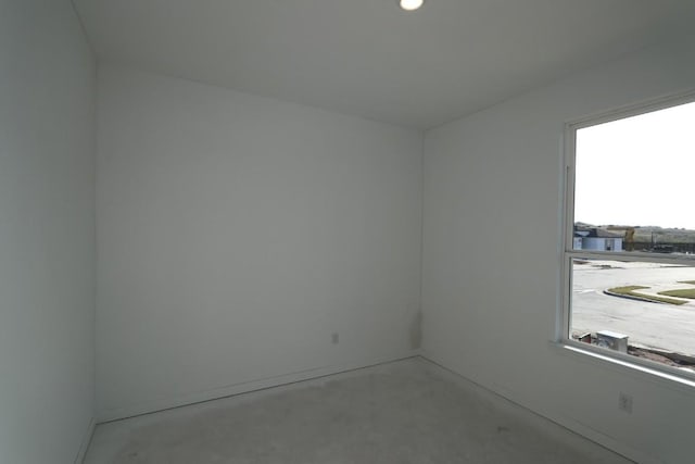 unfurnished room with concrete floors