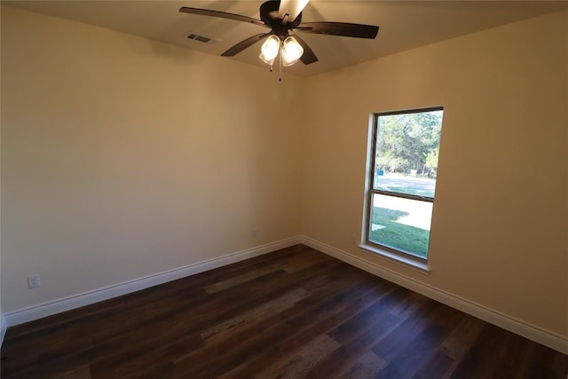 empty room with ceiling fan and dark wood-type flooring