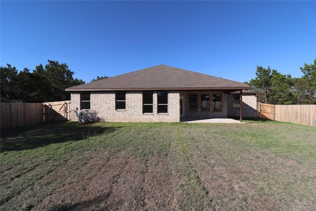 back of house with a lawn and a patio area