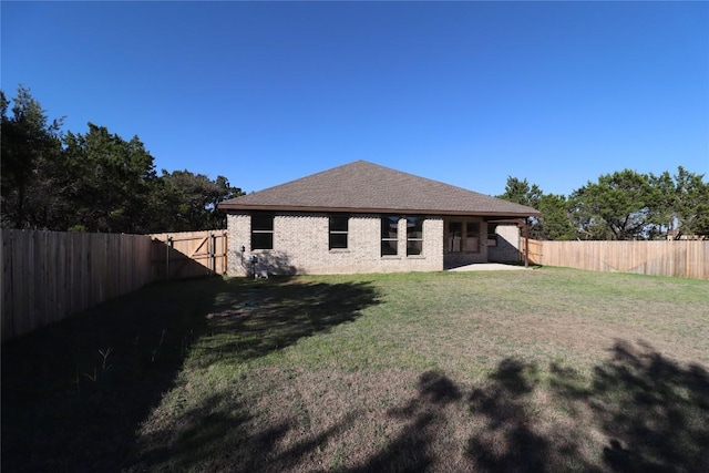 rear view of property with a patio and a lawn