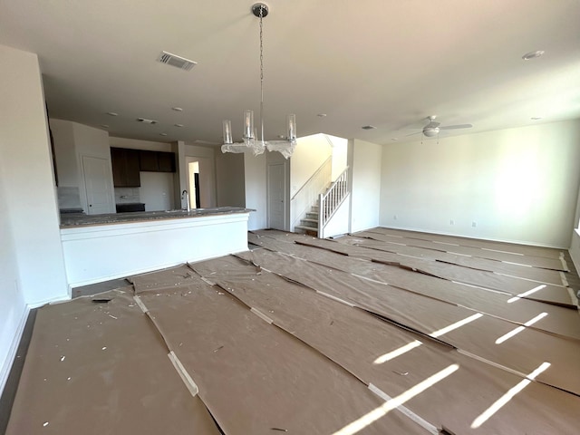 interior space featuring ceiling fan and sink