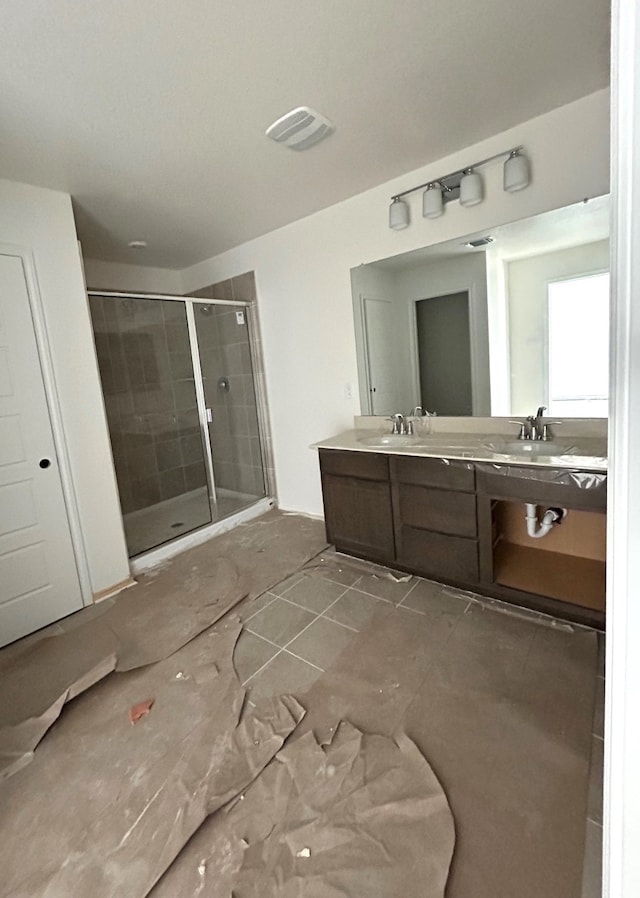 bathroom featuring vanity and a shower with shower door