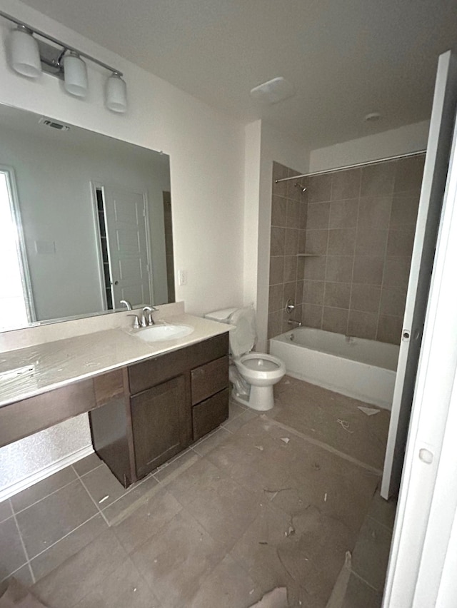 full bathroom featuring tile patterned floors, vanity, toilet, and tiled shower / bath