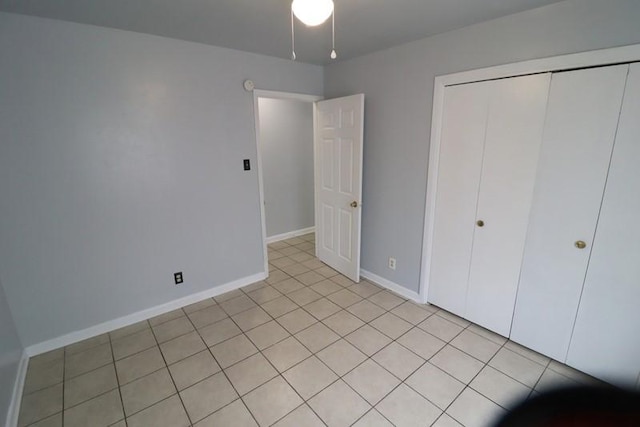 unfurnished bedroom featuring light tile patterned flooring and a closet