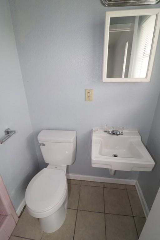 bathroom featuring tile patterned floors, sink, and toilet