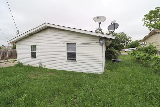 view of home's exterior with a yard