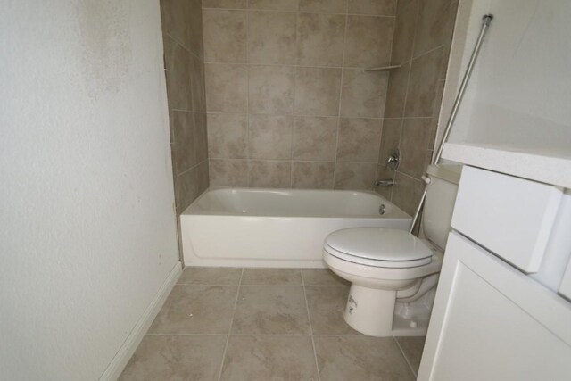 full bathroom with tile patterned flooring, tiled shower / bath combo, toilet, and vanity