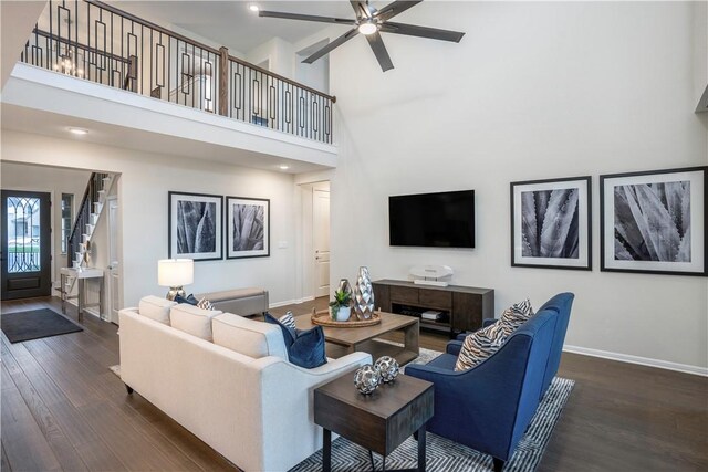 living room with ceiling fan, dark hardwood / wood-style flooring, and high vaulted ceiling