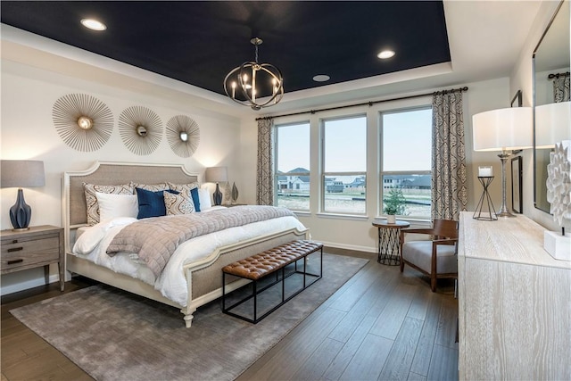 bedroom featuring dark hardwood / wood-style floors and a notable chandelier